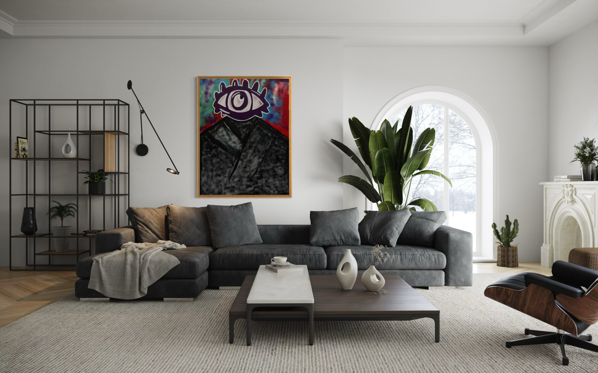 Adivino Gallery original purple eye figure artwork displayed above a gray sofa in a bright living room