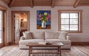 Space Flowers above a cream sofa in a cottage living room with timber beams, Smartist mockup.