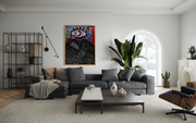 Adivino Gallery original purple eye figure artwork displayed above a gray sofa in a bright living room